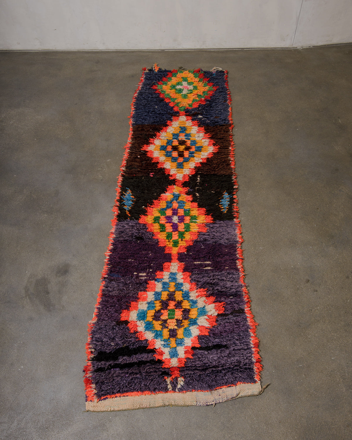 Colorful geometric-patterned rug on a concrete floor